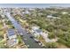 Aerial view of a waterfront neighborhood showcasing canal homes with docks and boats at 6914 Harbor Dr, Hudson, FL 34667