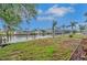 View of the waterfront backyard with boat dock and lift, perfect for enjoying the water and outdoor activities at 6914 Harbor Dr, Hudson, FL 34667