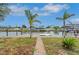 View from the canal showing a dock and backyard with palm trees and waterfront access at 6914 Harbor Dr, Hudson, FL 34667