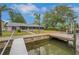 Waterfront home with a private dock, mature landscaping, and a serene setting for boating and relaxation at 6914 Harbor Dr, Hudson, FL 34667