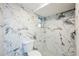 Modern bathroom featuring white marble-style tile throughout the walls and shower at 6914 Harbor Dr, Hudson, FL 34667