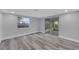 Neutral bedroom with a window view and sliding glass door to a lanai at 6914 Harbor Dr, Hudson, FL 34667