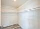 Walk-in closet with white walls, shelving and luxury vinyl plank flooring at 6914 Harbor Dr, Hudson, FL 34667
