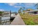 Waterfront property with a private dock, showcasing beautiful landscaping and serene water access for boating and leisure at 6914 Harbor Dr, Hudson, FL 34667