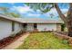 The front of a home featuring a gated entrance, stone accents, and well-maintained landscaping at 6914 Harbor Dr, Hudson, FL 34667