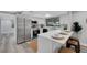 Modern kitchen featuring stainless steel appliances, white cabinets, and an eat-in bar area at 6914 Harbor Dr, Hudson, FL 34667
