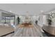 Inviting living room with wood-look floors and access to a screened lanai at 6914 Harbor Dr, Hudson, FL 34667