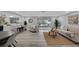 Bright living room with open floor plan, stylish furniture, and sliding glass doors leading to an outdoor space at 6914 Harbor Dr, Hudson, FL 34667