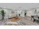 Cozy living room with wood-look floors, neutral decor, and a view of the front yard at 6914 Harbor Dr, Hudson, FL 34667