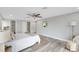 Well-lit bedroom featuring gray walls, and ceiling fan with a view of the bathroom and closet at 6914 Harbor Dr, Hudson, FL 34667
