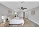Light-filled bedroom with a ceiling fan, light gray walls, and ample space at 6914 Harbor Dr, Hudson, FL 34667