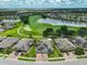Stunning aerial view of a home on a golf course with lush landscaping and lakes in the community at 724 Chipper Dr, Sun City Center, FL 33573