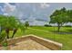 The patio overlooks lush golf course views, framed by mature palm trees and manicured lawns at 724 Chipper Dr, Sun City Center, FL 33573