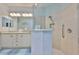Bathroom featuring double sinks, granite countertops, and a frameless glass shower at 724 Chipper Dr, Sun City Center, FL 33573