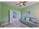 Cozy bedroom offering an additional sitting area with a plush couch and bright light at 724 Chipper Dr, Sun City Center, FL 33573