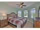 Bedroom with natural light and a ceiling fan overlooking well-manicured landscaping at 724 Chipper Dr, Sun City Center, FL 33573