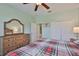 Cozy bedroom with ceiling fan, dresser and closet space at 724 Chipper Dr, Sun City Center, FL 33573