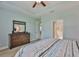 Light-filled bedroom with tray ceiling, wood floors, and en-suite bathroom access at 724 Chipper Dr, Sun City Center, FL 33573