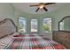 Bright bedroom with a ceiling fan, and a dresser set in front of bay windows at 724 Chipper Dr, Sun City Center, FL 33573