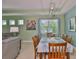 The dining area features a window with a view, wood table set and light green walls and tiled floors at 724 Chipper Dr, Sun City Center, FL 33573