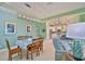 The dining area features wood table set under modern lighting next to an open kitchen with tiled floors at 724 Chipper Dr, Sun City Center, FL 33573