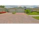 Exterior of the home featuring a double garage and brick paved driveway at 724 Chipper Dr, Sun City Center, FL 33573