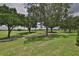 Scenic view of the golf course with mature trees providing shade and lush green fairways in the community at 724 Chipper Dr, Sun City Center, FL 33573
