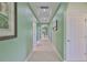 Hallway features arched doorways, recessed lighting, and neutral tile flooring at 724 Chipper Dr, Sun City Center, FL 33573