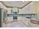 Updated kitchen features stainless appliances, glass tile backsplash, and granite countertops at 724 Chipper Dr, Sun City Center, FL 33573