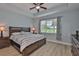 The main bedroom features a wood bed frame, ceiling fan, and a view to the golf course at 724 Chipper Dr, Sun City Center, FL 33573
