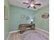 This office showcases a contemporary desk and decor, complemented by a ceiling fan and soft, neutral wall color at 724 Chipper Dr, Sun City Center, FL 33573