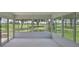 Enclosed patio with golf course view showcases light tile flooring and expansive windows offering a peaceful retreat at 724 Chipper Dr, Sun City Center, FL 33573