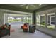 Bright sunroom with tiled floor, large windows, and comfortable seating overlooking the landscape at 724 Chipper Dr, Sun City Center, FL 33573