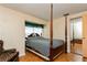 Bedroom with wood floors and a large bed, complemented by stylish accents and a built-in mirror at 7317 W Pocahontas Ave, Tampa, FL 33634