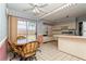 Bright kitchen area showcasing a breakfast nook with four chairs, tiled floors, and white cabinetry at 7317 W Pocahontas Ave, Tampa, FL 33634