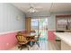 Sun-filled breakfast nook in the kitchen featuring vintage table and chairs, tiled floors, and a sliding door at 7317 W Pocahontas Ave, Tampa, FL 33634