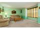 Bright living room offers natural light through a large window, complemented by comfortable furniture at 7317 W Pocahontas Ave, Tampa, FL 33634