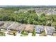This aerial showcases several homes with green lawns and community landscaping near a tranquil pond and lush greenery at 7518 Tangle Brook Blvd, Gibsonton, FL 33534