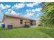 Picturesque backyard with a swing set, screened patio, and manicured lawn for outdoor living at 7518 Tangle Brook Blvd, Gibsonton, FL 33534
