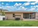 Inviting backyard featuring a lush lawn, comfortable swing set, and screened patio for relaxation at 7518 Tangle Brook Blvd, Gibsonton, FL 33534