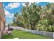 Scenic backyard showcasing a lush lawn, a swing set, and privacy fencing, perfect for outdoor activities at 7518 Tangle Brook Blvd, Gibsonton, FL 33534