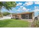 Well-maintained backyard with a screened-in patio, swing set, and lush lawn at 7518 Tangle Brook Blvd, Gibsonton, FL 33534