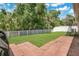 Spacious backyard featuring lush green grass, a privacy fence, and a swing set for outdoor enjoyment at 7518 Tangle Brook Blvd, Gibsonton, FL 33534