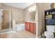 Well-lit bathroom featuring a glass-enclosed shower, soaking tub, and double vanity at 7518 Tangle Brook Blvd, Gibsonton, FL 33534