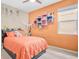 Bright bedroom with a full-sized bed, colorful wall decor, and large window for natural light at 7518 Tangle Brook Blvd, Gibsonton, FL 33534