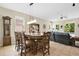 Open-concept dining room and living room combination with tile floors and large windows at 7518 Tangle Brook Blvd, Gibsonton, FL 33534