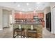 Modern kitchen featuring a central island with bar seating, stainless steel appliances, and stone backsplash at 7518 Tangle Brook Blvd, Gibsonton, FL 33534