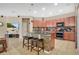 Open kitchen featuring a center island with bar stools, granite countertops, and stainless steel appliances at 7518 Tangle Brook Blvd, Gibsonton, FL 33534