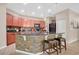 Modern kitchen featuring a center island with a stone facade, granite countertops, and stainless steel appliances at 7518 Tangle Brook Blvd, Gibsonton, FL 33534