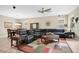 Spacious living room featuring a large sectional sofa, ceiling fan, and decorative rug at 7518 Tangle Brook Blvd, Gibsonton, FL 33534